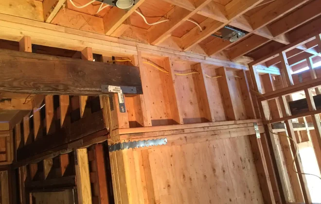 New electrical wiring run through open wall framing during a remodel by Tamar Electric